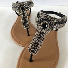 This Beautiful Sandal Will Compliment Any Outfit! Black And Diamond Colored Rhinestones Make This One A Real Show-Stopper! Bedazzled Flat Sandals For Evening, Bedazzled Flat Evening Sandals, Glamorous Adjustable Embellished Sandals, Evening Sandals With Embellished Adjustable Straps, Embellished Adjustable Sandals For Evening, Adjustable Embellished Sandals For Evening, Black Bling Sandals For Summer, Silver Bedazzled Flat Sandals, Summer Black Sandals With Bling