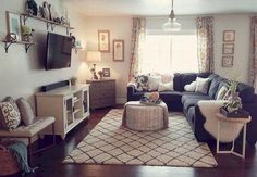 a living room filled with furniture and a flat screen tv mounted on the wall above it