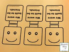 three signs with faces and words written in different languages are shown on a piece of paper