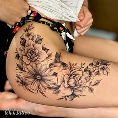 a woman's thigh with flowers on it