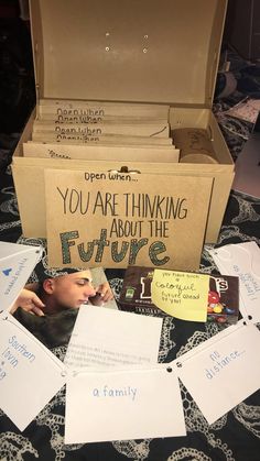 an open box with writing on it and some papers in front of it that say you are thinking about the future