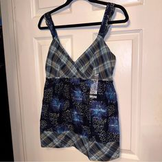 Cross Over Bust/Yoke In Plaid, Smocked At Back With Contrasting Spaghetti Straps With Ruffles Body In Print, Edged With A Plaid Bend That Has Topstitching Underarm 17” Flat In-Stretched Length 27 1/2” Location V Blue Cotton Camisole For The Beach, Beach Blue Cotton Camisole, Blue Calvin Klein Cotton Tops, Calvin Klein Blue Cotton Tops, Casual Blue Camisole For Beach, Blue Camisole For Vacation, Calvin Klein Cotton Tops For Summer, Blue Camisole With Adjustable Straps For The Beach, Blue Beach Camisole With Adjustable Straps