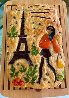 a cake made to look like the eiffel tower with fruit and vegetables on it