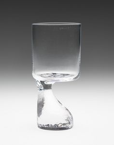 an empty glass sitting on top of a table