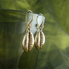 These beautiful cowrie shell earrings were cast from shells that we found on a beach in Asia, and by sanding down the back of the shell, we revealed the beautiful natural spiral inside. These have long been a female symbol of fertility and strength - time to unleash your inner Barbarella. Perfect little size, 16mm high by 10mm wide. Hung on our home made Lost Apostle earring hooks. Cast in the finest bronze, these really are lovely. They are hypo allergenic, so no problems for those of you with Traditional Nickel-free Earrings For Beach, Handmade Spiral Earrings For Beach, Cowrie Shell Earrings, Bone Ring, Cowry Shell, Female Symbol, Cowrie Shell, Shell Earrings, Earring Hooks