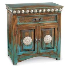 an old wooden cabinet with two doors and knobs