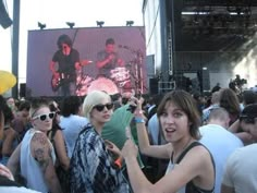 a group of people standing around each other at a concert