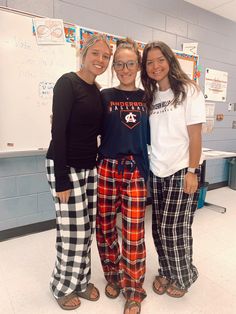 three girls are posing for the camera in pajama pants