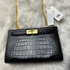 Tory Burch ‘Lee Radziwill’ Shoulder Bag New Never Used Tag Was Removed From The Bag Black ‘Lee Radziwill’ Shoulder Bag From Tory Burch. Crafted From Patent Leather With A Crocodile Skin Effect Throughout, This Design Features Distinctive Fastener, A Half-Round Handle, A Detachable And Adjustable Shoulder Strap And Interior With One Compartment. 100% Leather Height: 16cm Width: 26cm Designer Bags With Hasp Closure For Formal Occasions, Formal Clutch Bag With Turn-lock Closure, Elegant Evening Bags With Cc Turnlock Closure, Elegant Shoulder Bag With Cc Turnlock Closure, Formal Clutch With Cc Turnlock Closure, Elegant Crossbody Satchel With Cc Turnlock Closure, Elegant Black Bag With Cc Turnlock Closure, Elegant Clutch Bag With Turn-lock Closure, Elegant Clutch With Turn-lock Closure