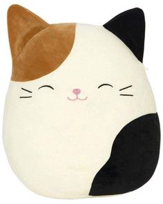 a white and black cat pillow with brown ears