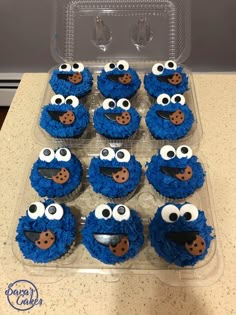 blue cupcakes decorated like cookie cookies with googly eyes and noses on them