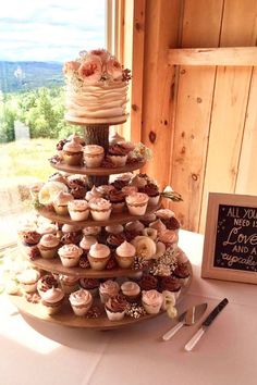 a wedding cake with cupcakes on it