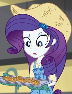 the pony is holding a tray with cookies on it