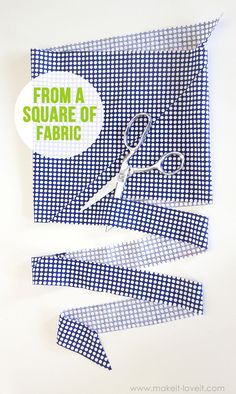 a pair of scissors sitting on top of a blue and white checkered cloth with the words from a square of fabric