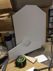 a white box sitting on top of a table next to a power tool and other items