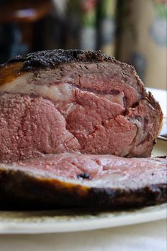 a piece of meat sitting on top of a white plate