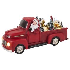 a red truck with santa claus in the back