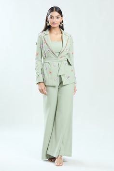 Sage green blazer featuring floral sequin hand embroidery in the front and sleeves. Paired with a flared solid pant a bustier and a belt. - Aza Fashions Fitted Workwear Sets With Floral Embroidery, Fitted Floral Embroidery Sets For Workwear, Fitted Floral Embroidery Sets For Work, Fitted Sets With Floral Embroidery For Work, Fitted Embroidered Pants For Workwear, Embroidered Fitted Pants For Workwear, Spring Green Fitted Pantsuit, Lapel Jacket, Green Blazer