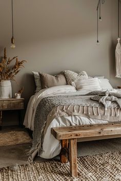 a bed sitting in a bedroom next to a wooden table and two hanging baskets on the wall