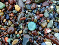 many different colored rocks and pebbles on the ground