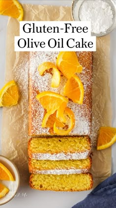 an orange cake with powdered sugar on top and slices cut out to show the filling