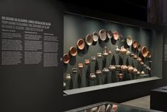 there are many bowls on display in the museum