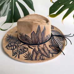 This Hat is Burned using Pyrography Techniques. Each Hat burned is drawn freehand therefore each one is a ONE of a KIND. Hats are all sprayed for weather and wear. Each Hat comes with a handcrafted Macrame Wall Hanger & a Signature Dust/Travel Bag. Felt Burned Hats, Burned Hats For Women, Derby Hat Diy, Pyrography Techniques, Burned Hats, Macrame Wall Hanger, Hat Diy, Painted Hats, Velvet Hat