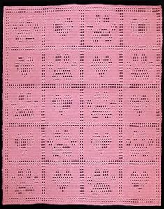 a pink crocheted square with letters on it