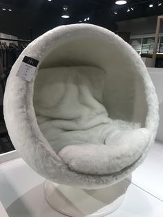 a white chair that is on display in a store