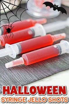 three halloween syringe jello shots on a table