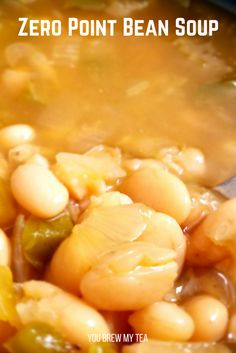 a bowl filled with beans and vegetables next to a spoon