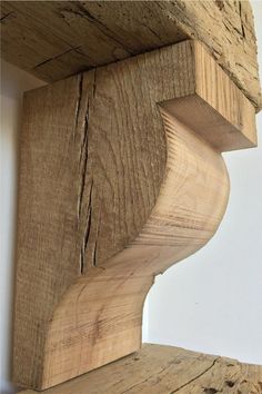 the corner of a wooden shelf made out of wood