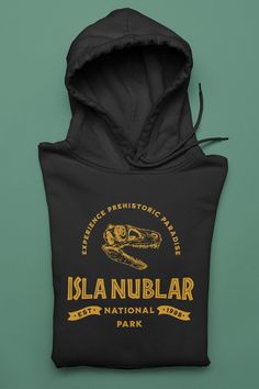 Jurassic Park Isla Nublar National Park unisex Hoodie! Experience Prehistoric Paradise!  Artwork inspired from the Jurassic Park and Jurassic World Movie Series.  A cool geeky parody Hoodie Sweatshirt for Jurassic Park Lovers and National Park Lovers, a comfortable Tee for Dinosaur Lovers, or Jurassic Park Lovers!  Jurassic Park Hoodie, Jurassic World Hoodie, Isla Nublar Hoodie, Isla Nublar Travel Hoody, Dinosaur Funny Hoodie, Jurassic Park sweatshirt, Movie Hoodie, Ingen Hoodie, 90's Hoodie, Ad Jurassic Park Sweatshirt, Jurassic Park Clothes, Movie Sweatshirts, Paradise Artwork, National Park Sweatshirt, Jurassic World Movie, Dinosaur Hoodie, Isla Nublar, Job Clothes