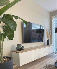 a living room filled with furniture and a flat screen tv mounted to the side of a wall