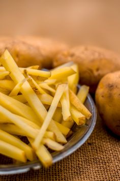 some potatoes are sitting on a plate next to each other