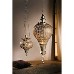 Featuring an attractive antique silver tone, and filigree embroidery pattern in oriental style, this metal hanging oriental wind light provides a cozy atmosphere whether on the terrace or in the living room. You will find the corresponding large hanging wind light here !!! Small Dimensions: 6.7" Dia x 11.4" H without chain, 28.75" H with chain, Glass insert 2.75" Dia x 2.36" H;  Weight: approximately 0.8 lbs; Material: Metal with filigree embroidery pattern in oriental style; Uses: stylish decor Filigree Embroidery, Ramadan Lantern, Boho Items, Wood Lantern, Lantern Candle Decor, Moroccan Lamp, Lantern Lamp, Metal Lanterns, Design Toscano