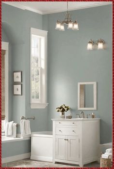 a bathroom with blue walls and white fixtures