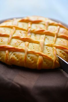 a close up of a pastry on a plate with a knife