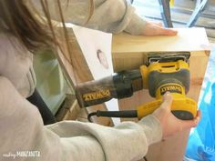 Using a hand sander and 220 grit sandpaper, give both the bathroom floating shelves base with the sides and top attached, as well as the boards you cut for the bottom and front panel a good sanding. Definitely make sure you get the places where the wood putty is on the nail spots really well so the surface is smooth. After you're done sanding, wipe down the wood with a slightly damp rag to get all the sanding dust. #sanding #sander #dewalt #shelf How To Arrange Bedroom, Shelves Above Couch, Grey Floating Shelves, Diy Shelf Brackets, Bedroom Furniture Ideas, Under Tv, Bedroom Arrangement, Oak Floating Shelves