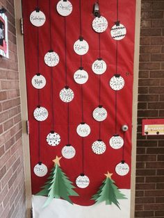 a door decorated with christmas decorations and hanging from the side, in front of a brick wall