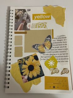 an open notebook with yellow pages and pictures on the page, including flowers and butterflies