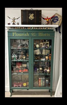 a display case with lots of items on top of it in front of a wall