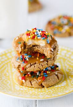 three cookies stacked on top of each other with sprinkles and frosting