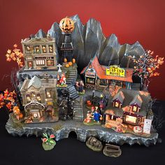 a halloween scene with buildings and pumpkins on display