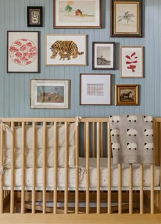 a baby's crib with pictures on the wall