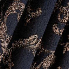 the curtain is made up of black and gold fabric with an intricate design on it