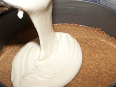 a person mixing cream in a pan on the stove