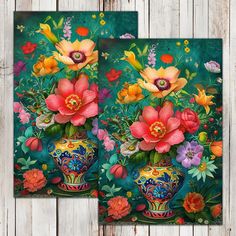 two vases with flowers painted on them sitting next to each other in front of a wooden wall