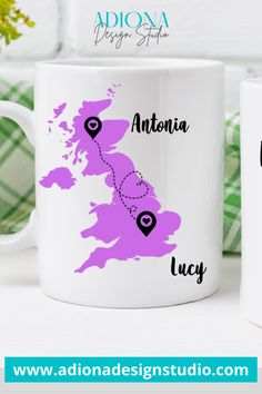 two coffee mugs with the names and location of destinations on them, sitting next to each other