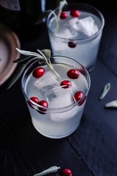 two glasses filled with ice and cherries